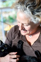 Caroline Bobby holding a black cat in her arms